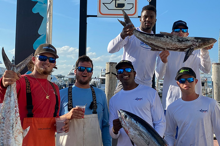 Winning team weighing in a trophy sailfish at the marina dock